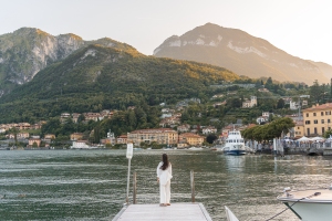 Image of Bianca admiring the sunset at Lake Como, a breathtaking view of the serene lake surrounded by picturesque mountains, offering a moment of tranquility and beauty.